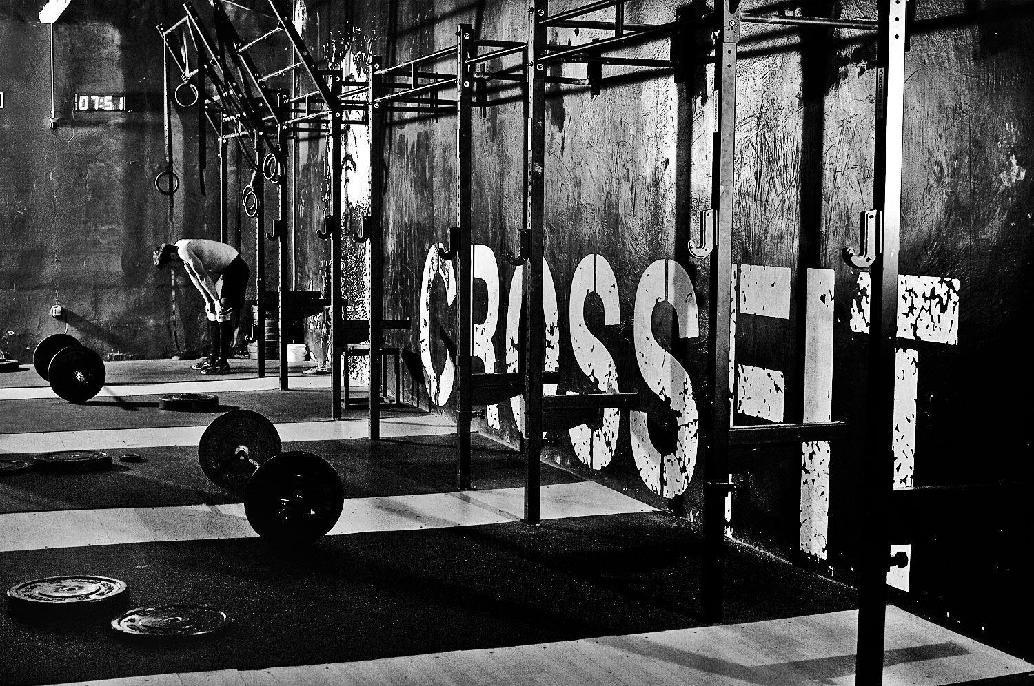CrossFit gym with barbells and a pull-up rig