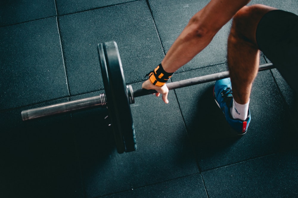 Close-up of an athlete gripping a loaded barbell