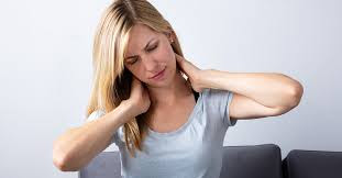 Woman rubbing her sore neck